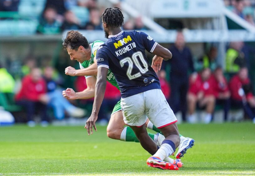 Billy Koumetio chops down Joe Newell on the edge of the area. Image: Simon Wootton/SNS