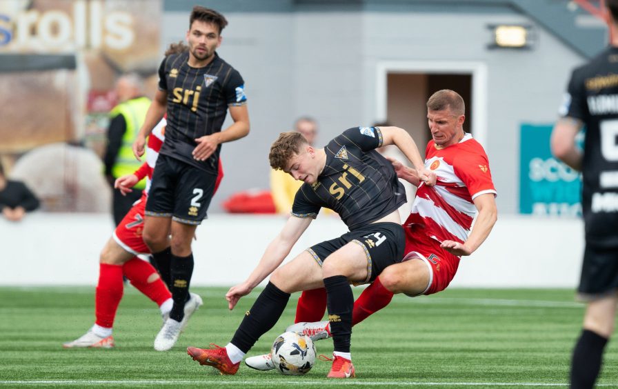 Dunfermline striker Taylor Sutherland tussles with Hamilton defender Sean McGinty.