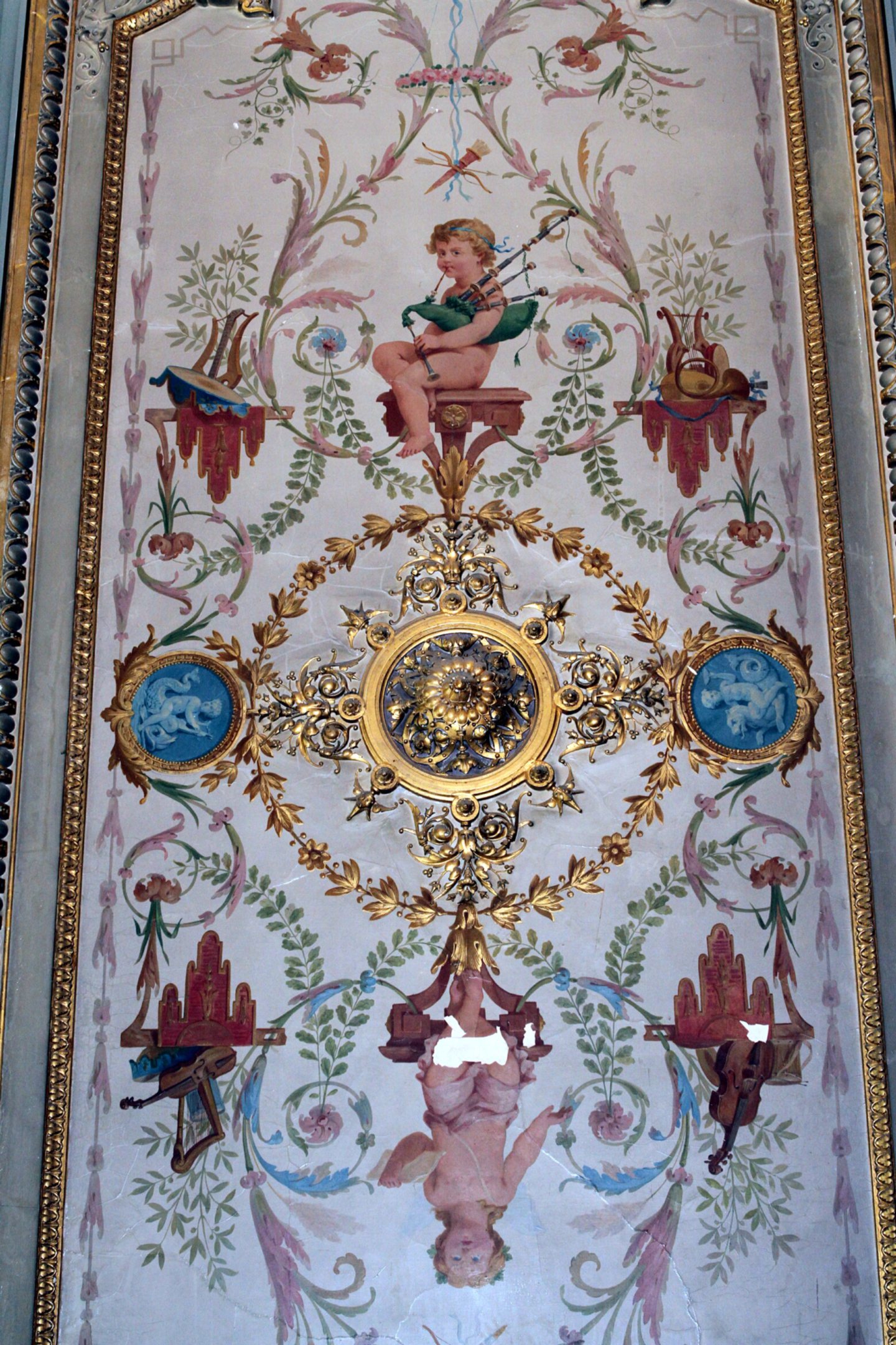 The smaller of the ornamental ceilings at Carbet Castle, which features cherubs playing the bagpipes 