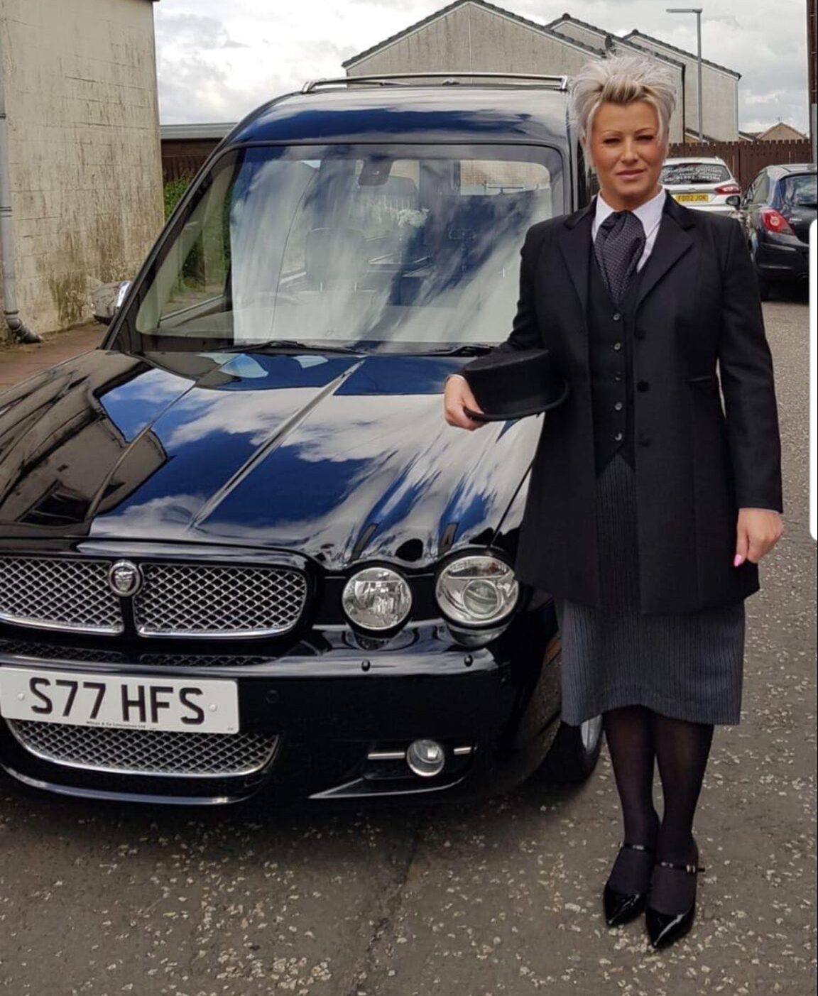 Angela directing her first funeral, her smiling hiding her nerves.