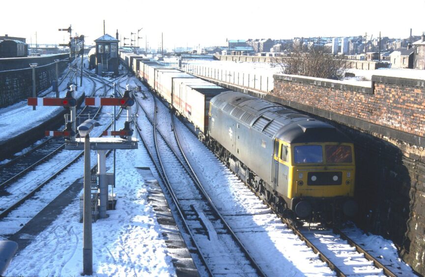 A northbound Freightliner with snow on the tracks.