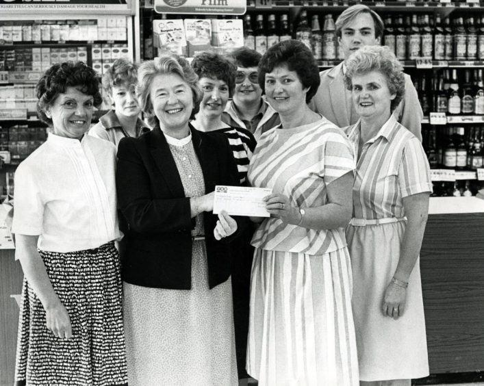 A group of women with a cheque following some fundraising at the Barnhill William Low in 1985.