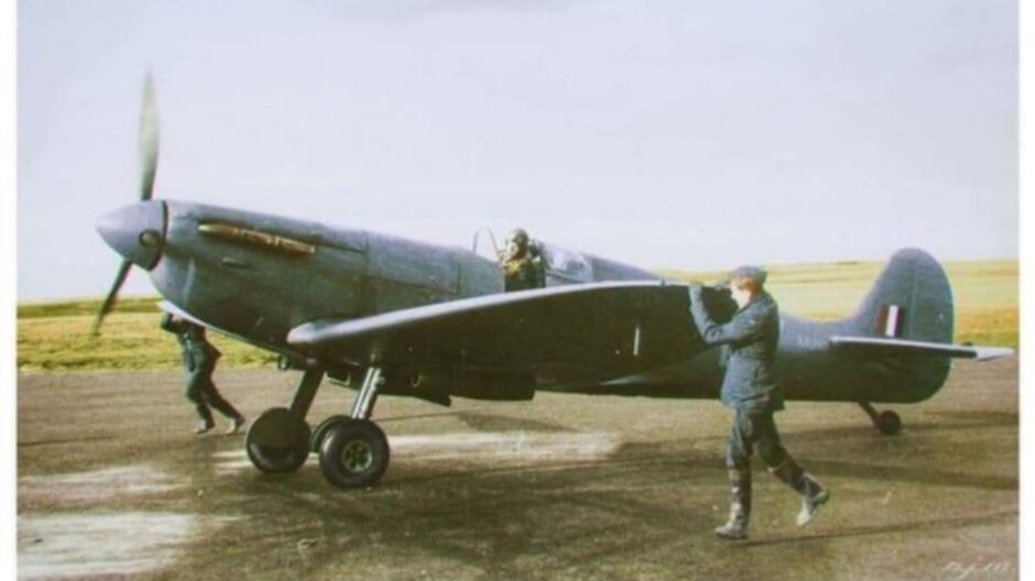 Wartime photo of Spitfire airplane on runway at Wick with two airmen running alongside