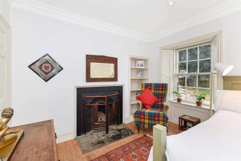 A fireplace in the third bedroom. 