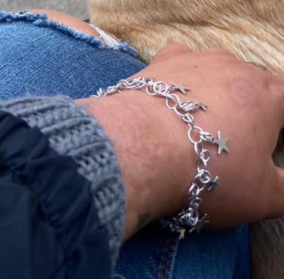 Silver bracelet with star charms on Bethany Haines' wrist