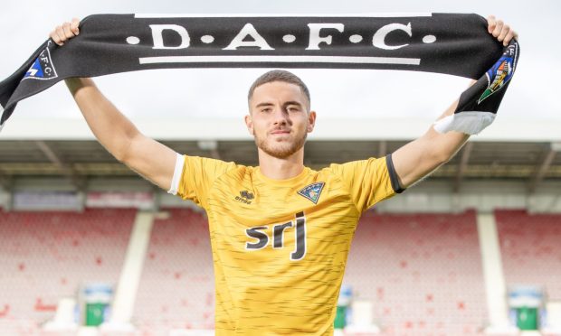 New signing Tommy Fogarty holds up a Dunfermline Athletic scarf at East End Park.