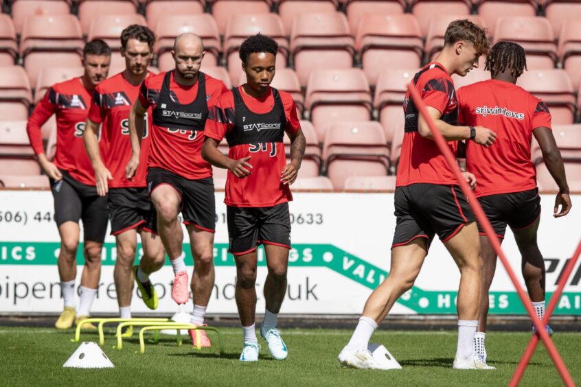 The Dunfermline Athletic FC players go through their warm-up drills.