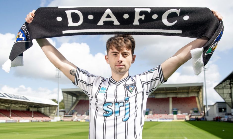 Josh Cooper holds up a Dunfermline Athletic F.C. scarf after signing a one-year deal.