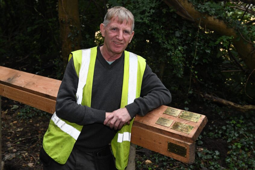 Ronnie Collins from West Fife Woodland Group with some of the dog memorial plaques already added.