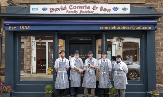 Murray Lauchlan (second from left) and Colin Howat (third from left) in front of David Comrie and Son Butchers.