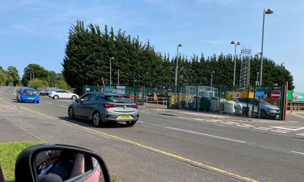 Cars are reversing out of Dalgety Bay recycling centre.