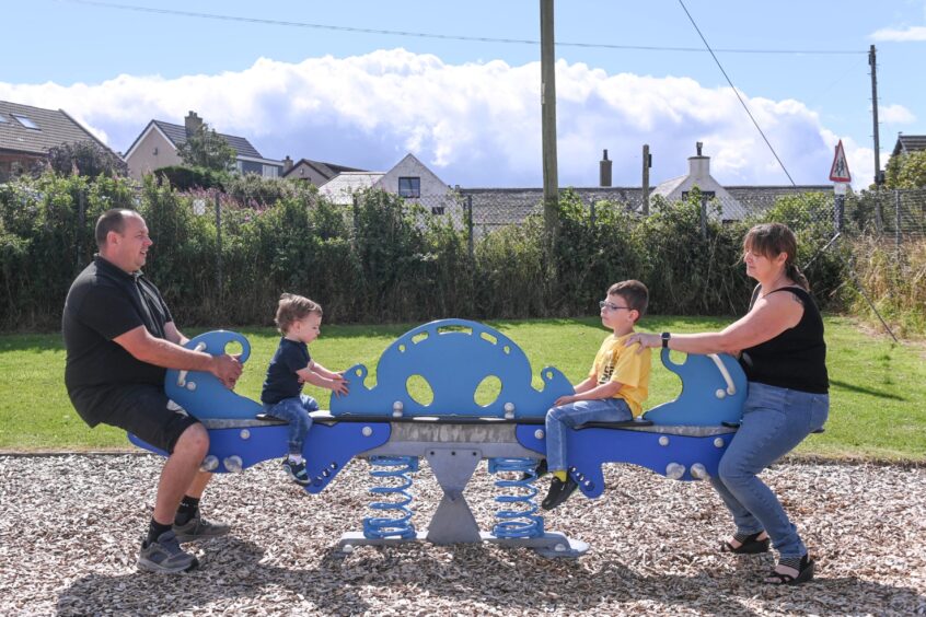 The Meston family on a seesaw