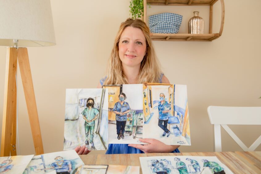 Gilly with her drawings of the NHS staff who cared for her at Ninewells Hospital.