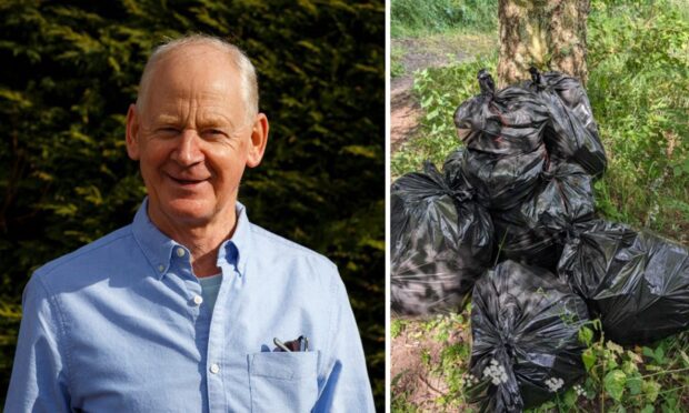 Frank Smith next to black bags of rubbish