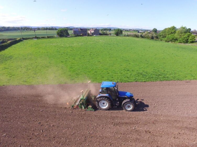 A tractor planting sunflower seeds.