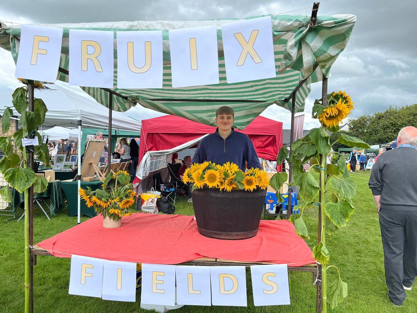 Fraser Turnbull selling sunflowers at Kinross Farmers' Market in 2023