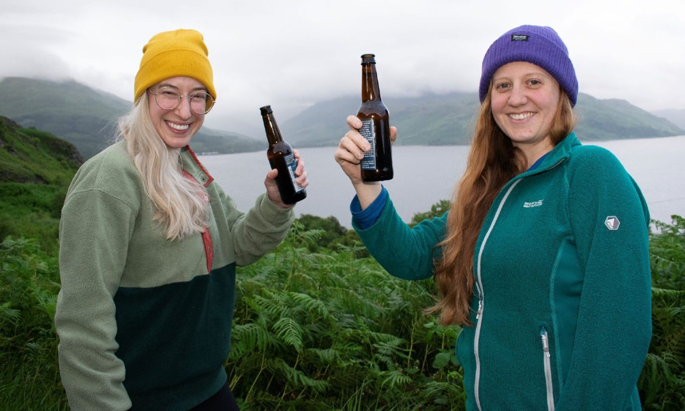 Broughty Ferry-based scientist Glynis Mattheisen (left) and friend Ally Turner raise a bottle after hiking for three days to reach Scotland's remotest pub. Image: BBC