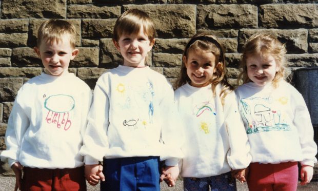 4 Eastern Primary nursery school children sporting sweatshirts they designed themselves.