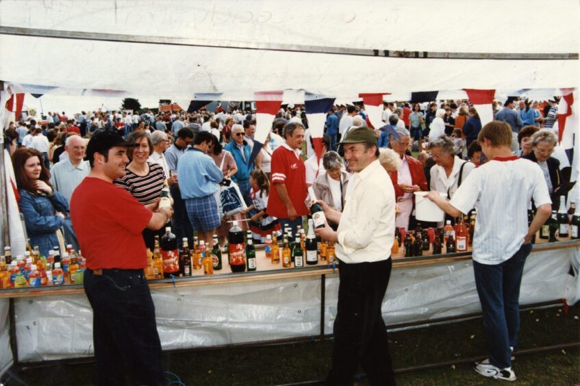 Downfield Musical Society members man their bottle stall on Castle Green