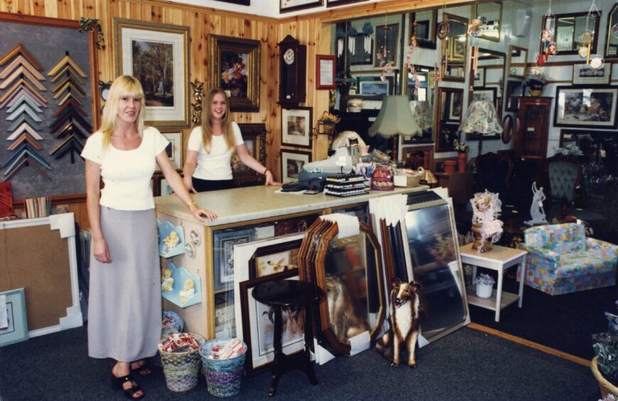 Staff members at the counter at the Gift Emporium. 