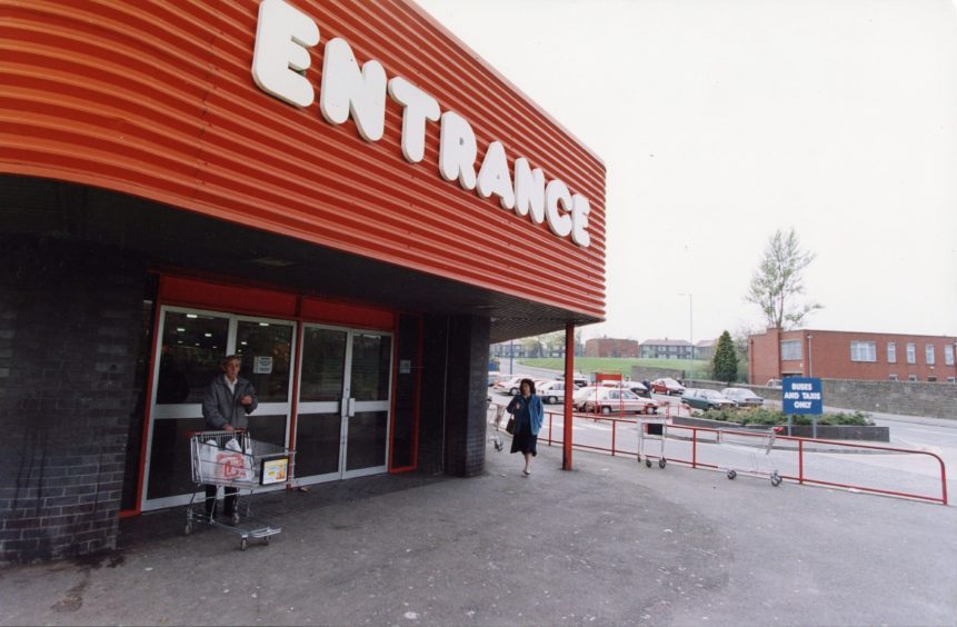 a man with a trolley outside the entrance to the Pitkerro Road store, which closed in 1993.