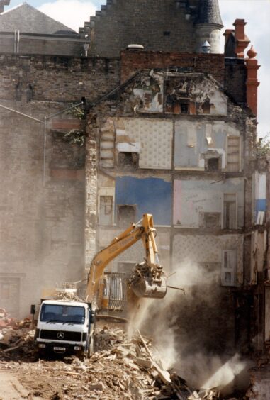 The red frontage of the Vic can be seen as the bulldozers move in. 