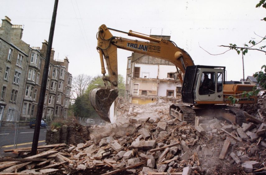 A digger sits on a pile of rubble as The Two Brewers is demolished 