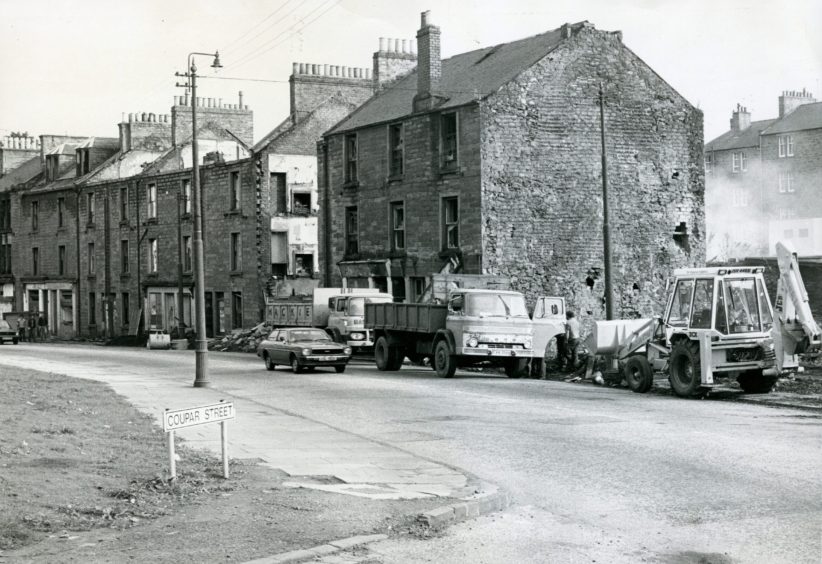 Vans and a digger on the street in Lochee for the Logie Street demolition