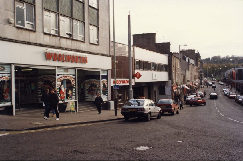 A view down Lochee High Street showing the frontage of the Woolworths store