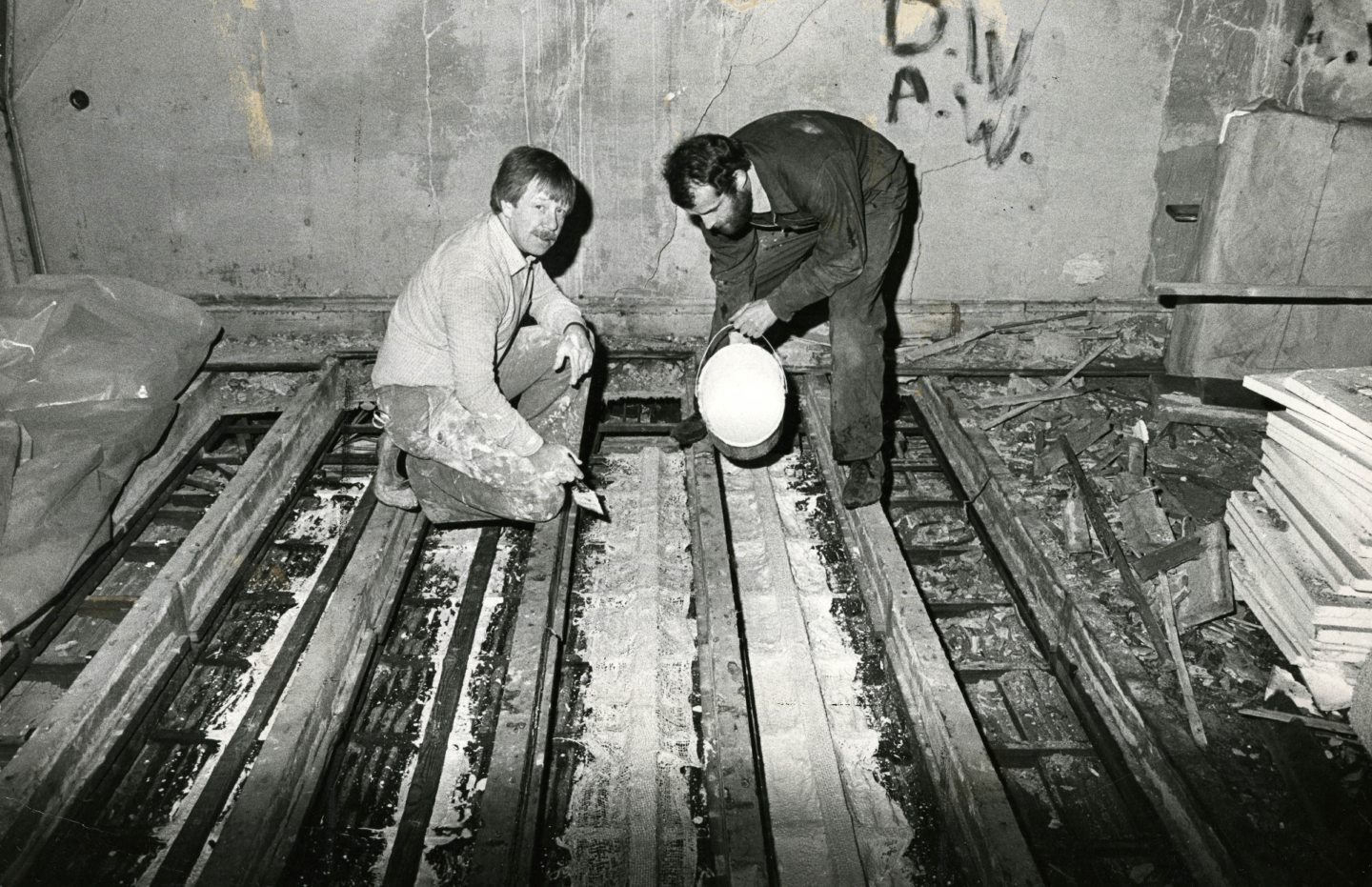 Neil McGregor and Neil Grieve working on the joists above the ceiling in 1984.