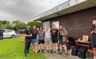 Group of men giving thumbs up outside Blairgowrie Rugby Club premises