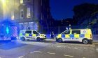 Police descended on Meadowside, at the junction with Reform Street. Image: Ellidh Aitken/DC Thomson