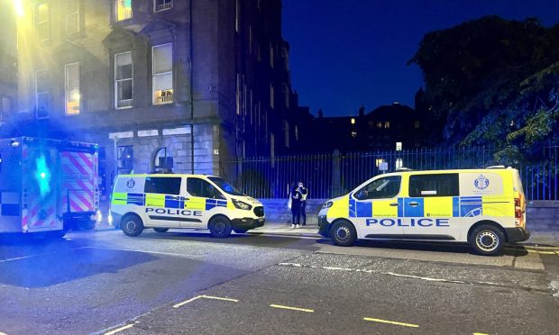 Police descended on Meadowside, at the junction with Reform Street. Image: Ellidh Aitken/DC Thomson