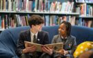 Two students from the Highschool of Dundee reading a book.