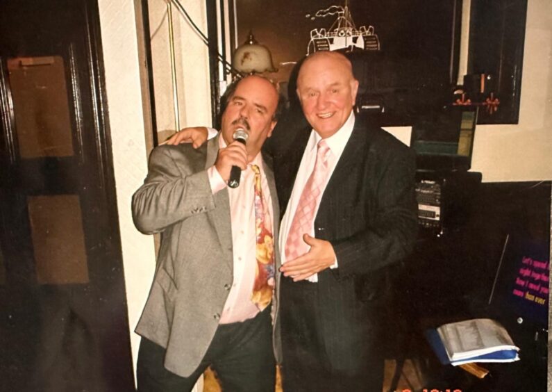 Joe Roberts singing with his dear friend the late Sheriff Richard Davidson. Image: Supplied.