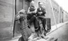 Two smiling workers photographed sitting on the camel at Bowbridge Works in 1955.