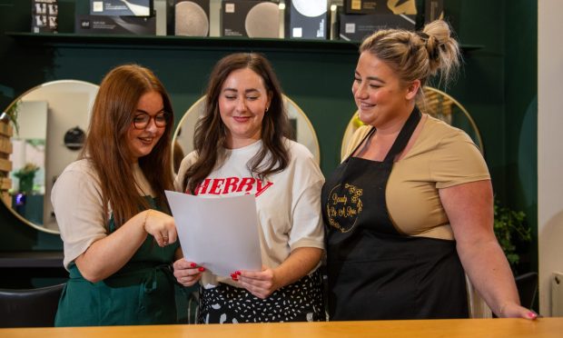 Abby Kane, Steph McLaren and Rosie Forrester with the letter. Image: Kim Cessford/DC Thomson.