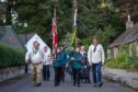 Scouts Malcolm Scott (left) and Kai Rena lead the flag parade through Glamis. Image: Kim Cessford / DC Thomson