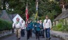 Scouts Malcolm Scott (left) and Kai Rena lead the flag parade through Glamis. Image: Kim Cessford / DC Thomson