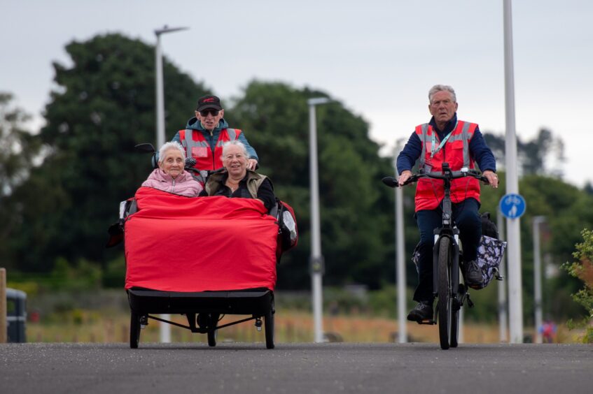 From L to R: Theresa Baxter, Steve Robertson (volunteer), Anne Gowdy and Bob North (volunteer) using the Active Travel route from Monifieth to Broughty Ferry on the trishaw.