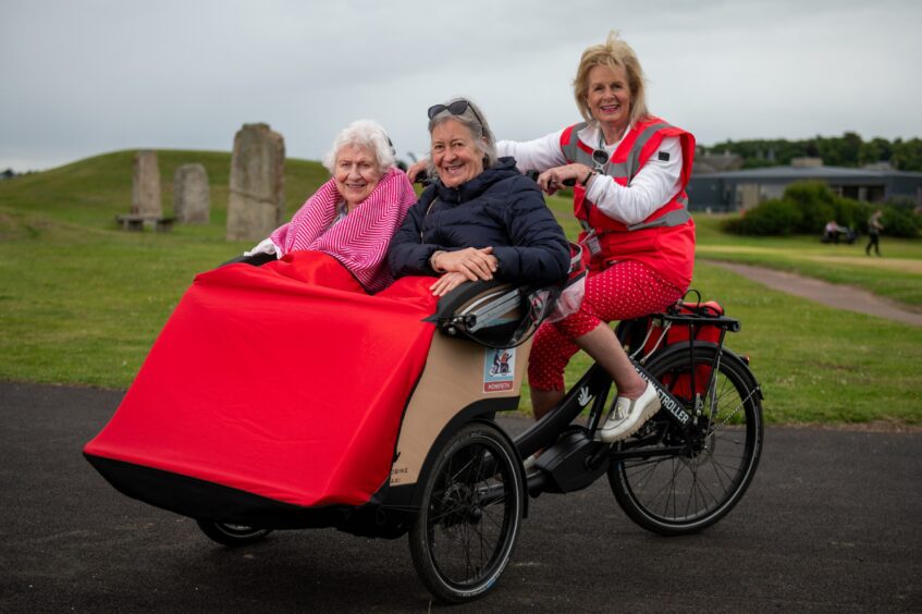 Passengers Elma Cathro and Elizabeth Shaw and Vivien Scott (volunteer pilot) on one of the trishaws.