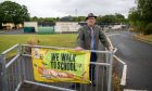 Councillor Jonny Tepp outside Newport Primary School, where is concerned about parking