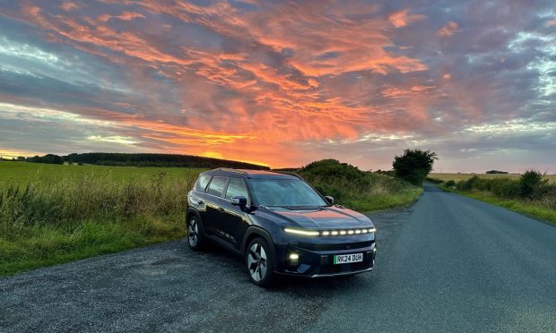 The KGM Torres EVX on a sunset hillside in Fife.