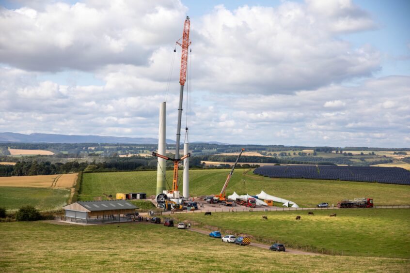 Wind turbine being constructed near Findony Farm with large crane and Perthshire scenery around it