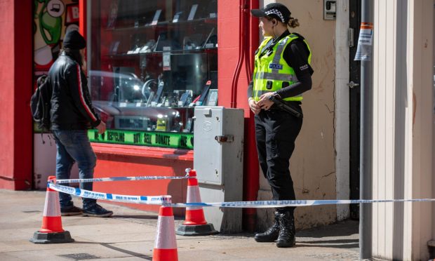 Police guarding a door on Kirkcaldy High Street after the alleged attack. Image: Kenny Smith/DC Thomson