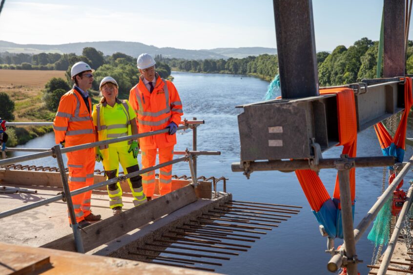 John Swinney on visit to Destiny Bridge as two workers explain work on crossing over Tay