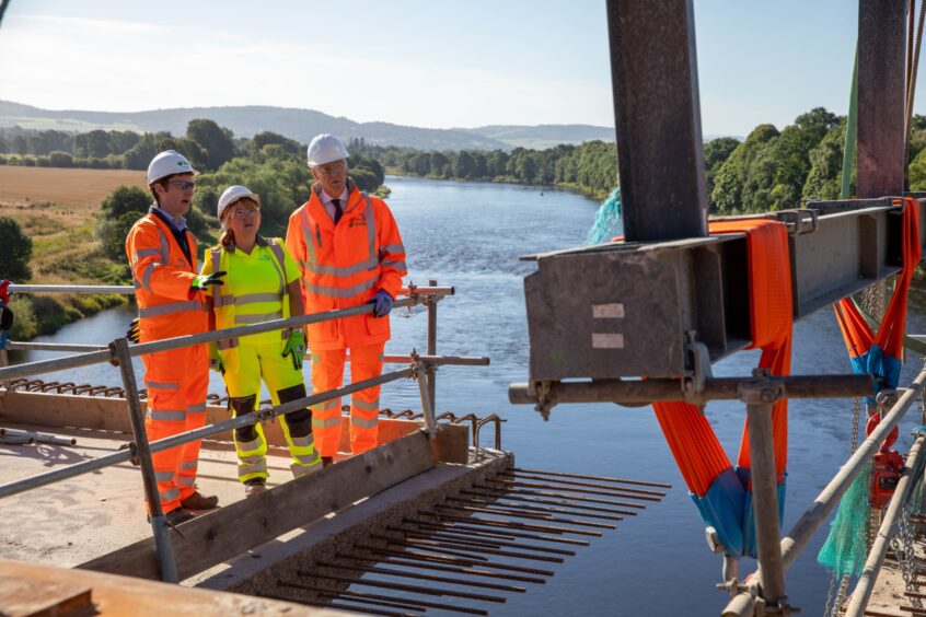 Derek Walsh, Contracts Manager for BAM UK &amp; Ireland; Jillian Ferguson, Roads Infrastructure Manager for Perth and Kinross Council, and First Minister John Swinney looking at construction work on bridge