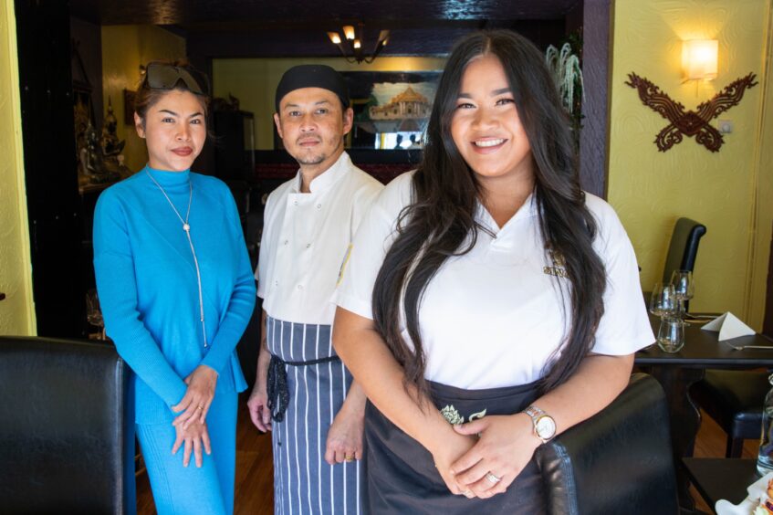 Nongmay with her parents at their restaurant in Perth.