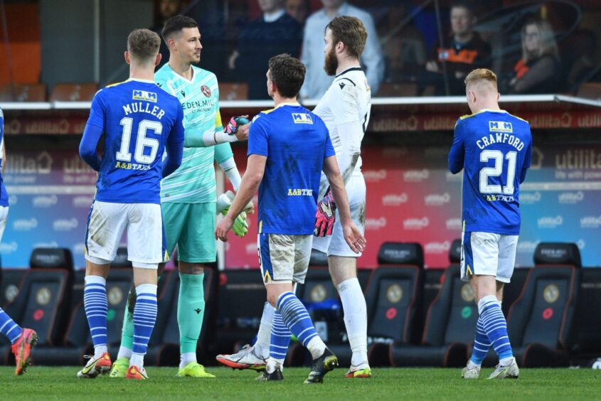 Clark, white, and Siegrist, green, in a show of respect after the Saints keeper's fine display