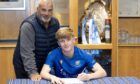 St Johnstone academy boss Alistair Stevenson watches as teen prospect Callan Hamill signs his new contract. Image: Graeme Hart/PPA